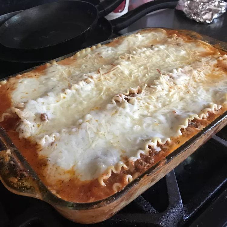 Lasagna cooling off on a stove